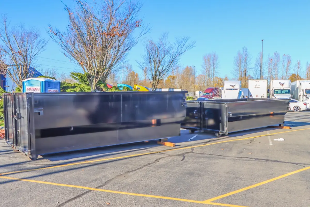 Professional dumpster rental service with roll-off container on residential driveway in DuBois